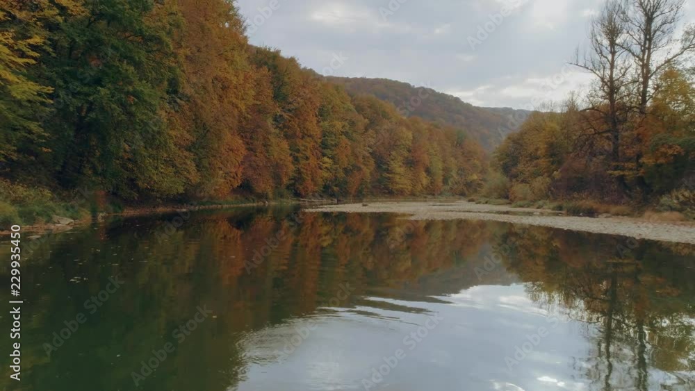 Aerial view: Flying along the river. Incredible colorful autumn view Aerial view: Flying along the river. Incredible colorful autumn view