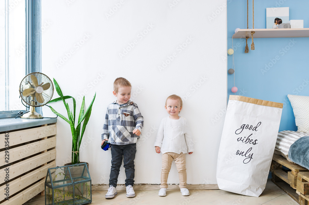Two happy siblings at home. Love and friendship between siblings concept