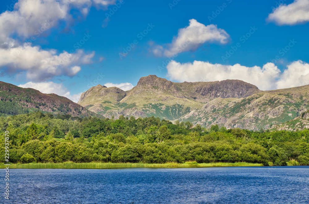 A view of The Langdale Pikes from Elterwater on a sunny day.