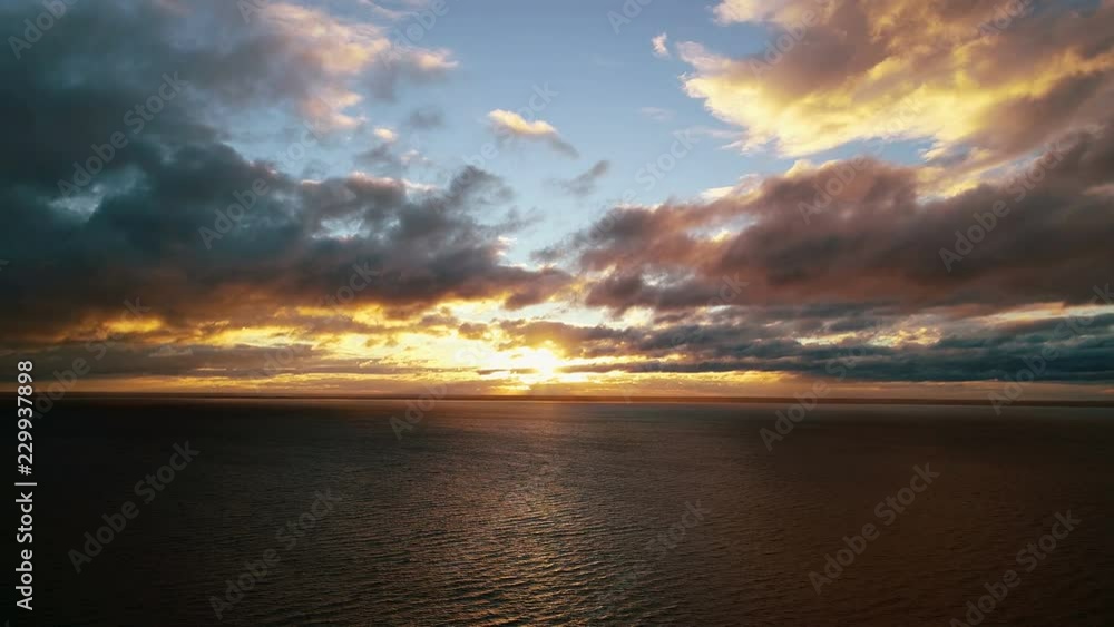 The flight above the water on the beautiful sunrise background The flight above the water on the beautiful sunrise background