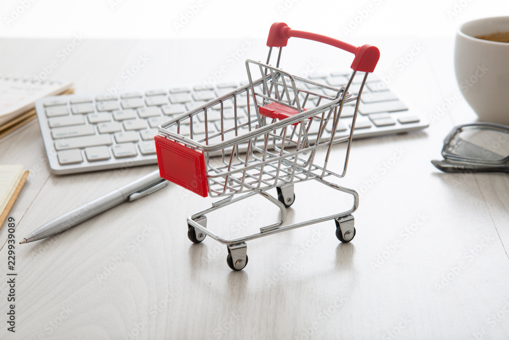 shopping cart on a laptop keyboard. Ideas about e-commerce, e-commerce or electronic commerce is a transaction of buying or selling goods or services online over the internet.