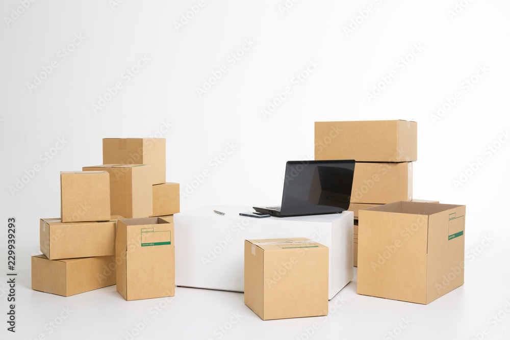 laptop computer at workplace of start up, small business owner, freelance, seller. cardboard parcel box of product for deliver to customer. Online selling, e-commerce, packing, shipping concept laptop computer at workplace of start up, small business owner, freelance, seller. cardboard parcel box of product for deliver to customer. Online selling, e-commerce, packing, shipping concept