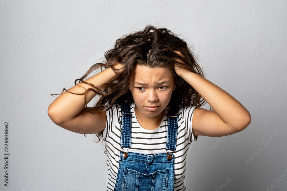 Portrait girl sitting with striped vest isolated. Portrait girl sitting with striped vest isolated.