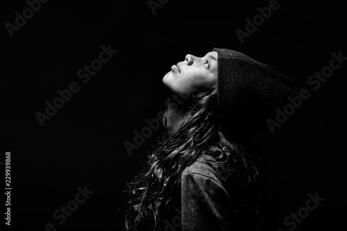 Young woman with hat on head and looks up