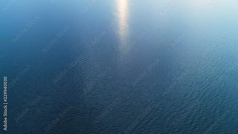 The flight above the picturesque sea on the cloud stream background The flight above the picturesque sea on the cloud stream background