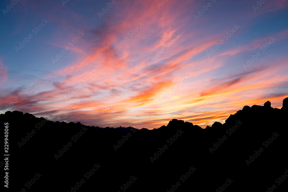 Mountains silhouettes on colorful sunrise