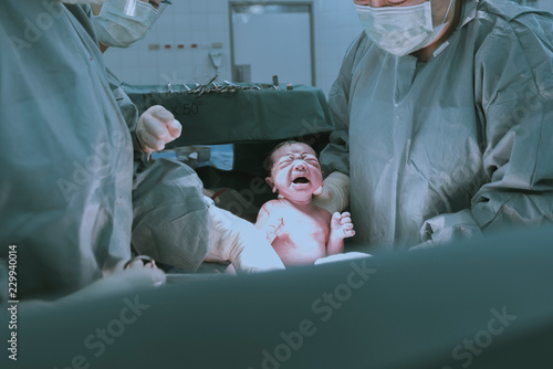 Tapet Doctors and assistants perform cesarean NEWBORN BABY GIRL