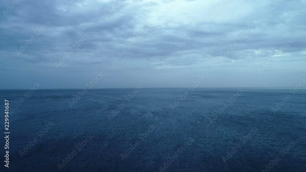 The flight above the ocean on the cloud stream background The flight above the ocean on the cloud stream background