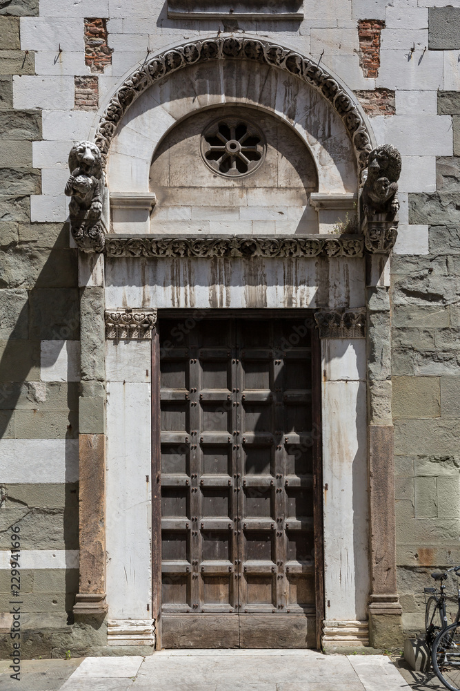 Decorative old wooden door in Lucca, Italy