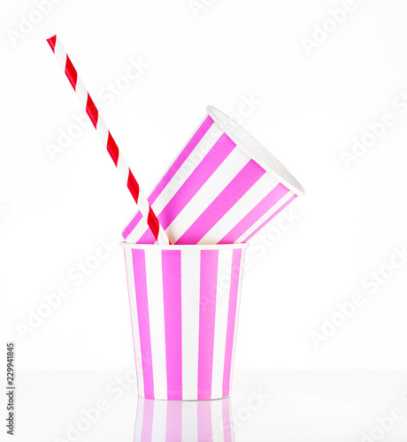 Pink striped paper cups with colored tubes.Close Up.