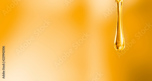 liquid droplet of motor oil on orange background