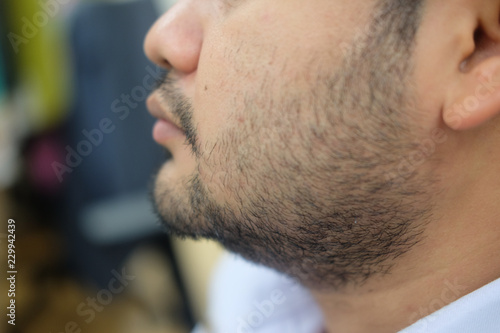 Close-up of a young man with beard and mustache