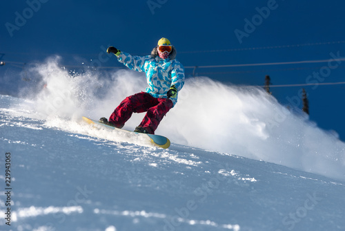 Fast snowboarder ski slope freeride