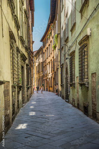 Tourists wandering in a small street in Lucca  Tuscany