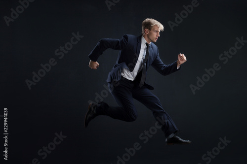 Fast business. Running businessman in business suits, concept