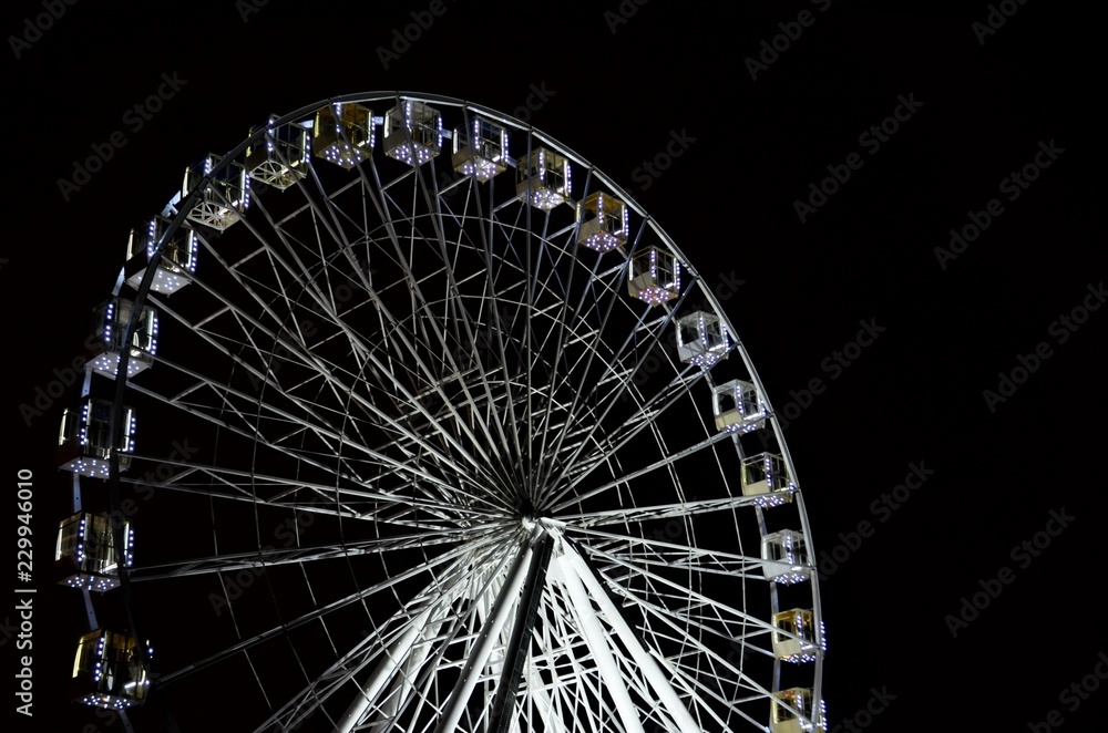 Ferris wheel at night on black background