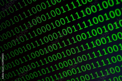 Binary code in green font on a black background, photo