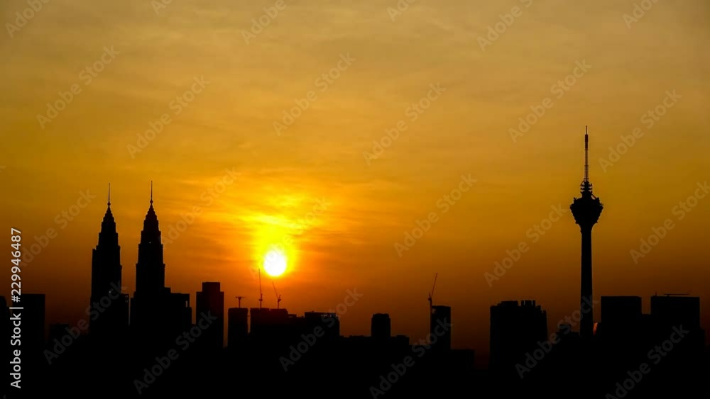 Silhouette of Kuala Lumpur city skyline basking under the warm glow of golden morning light during sunrise.
Silhouette of Kuala Lumpur city skyline basking under the warm glow of golden morning light during sunrise.