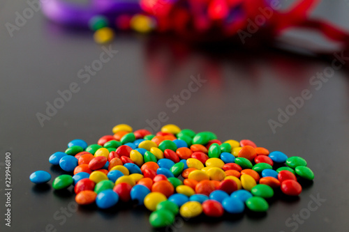colorful chocolate buttons on a black background
