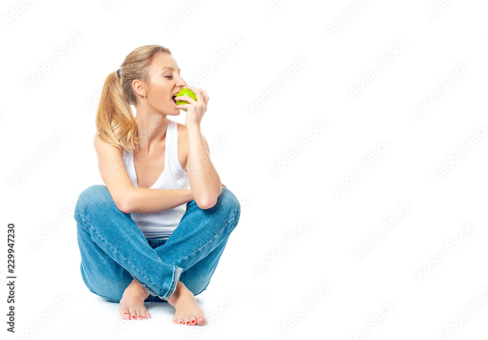 Beautiful woman is eating apple on white background. Healthy lifestyle and diet concept. Beautiful woman is eating apple on white background. Healthy lifestyle and diet concept.
