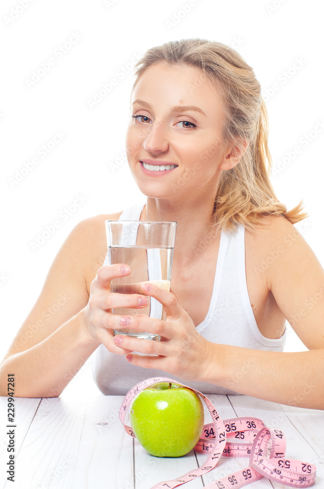 Beautiful woman with glass of water and apple isolated on white background Beautiful woman with glass of water and apple isolated on white background