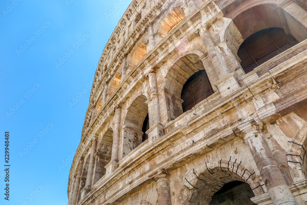 Detail of the facade of the Colosseum under a sunny day. Rome Italy.