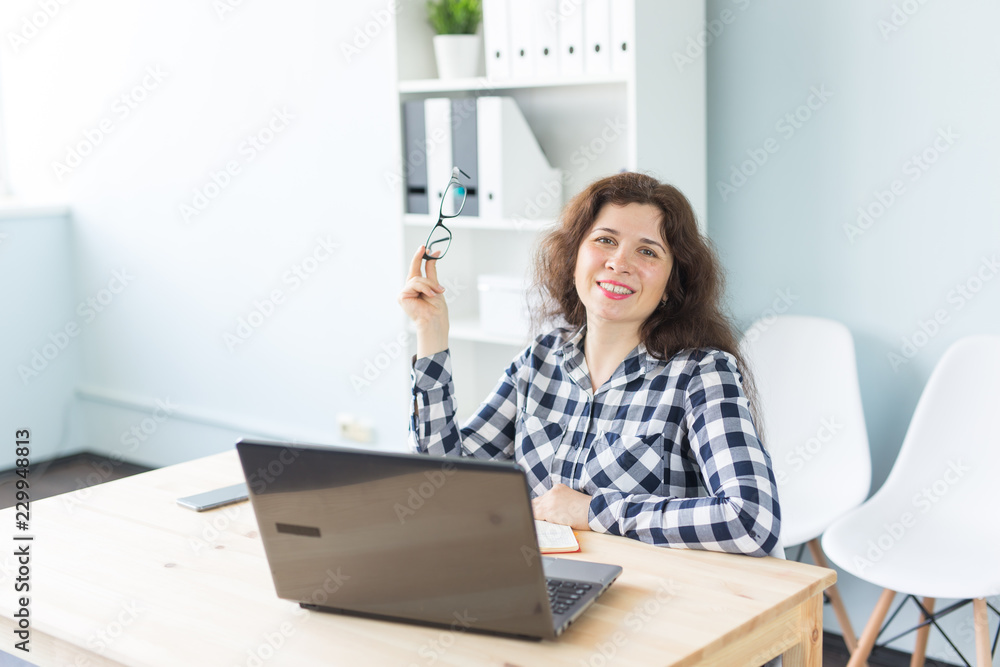 Coworking, graphic designer and business people concept - woman is working at the office with laptop Coworking, graphic designer and business people concept - woman is working at the office with laptop