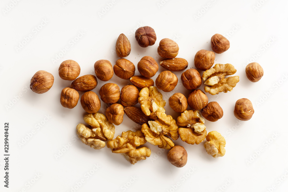 Overhead image of assorted nuts on white background with copy space Overhead image of assorted nuts on white background with copy space