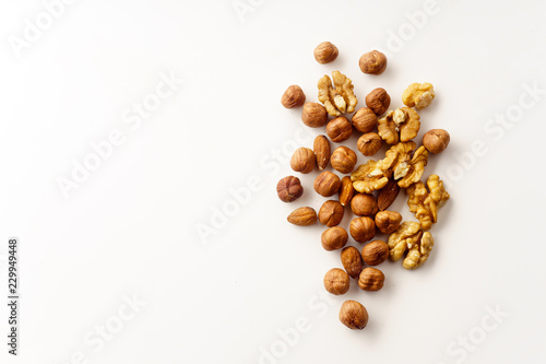 Overhead image of assorted nuts on white background with copy space