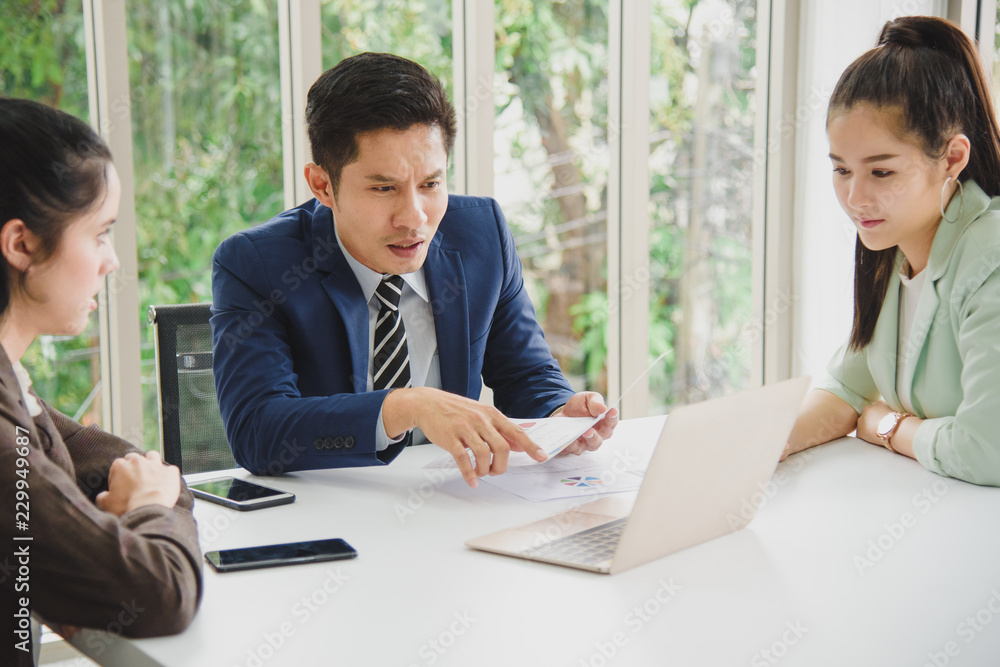 Three Business People Meeting working in office for discussing with a computer laptop and paper document sheet Three Business People Meeting working in office for discussing with a computer laptop and paper document sheet