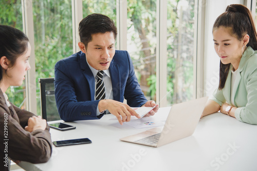 Wallpaper Mural Three Business People Meeting working in office for discussing with a computer laptop and paper document sheet Torontodigital.ca