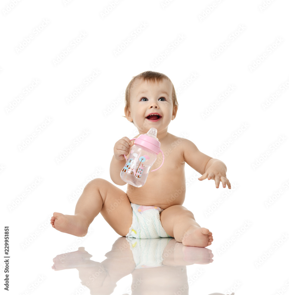 Infant child baby girl toddler hold drinking feeding bottle happy smiling looking up Infant child baby girl toddler hold drinking feeding bottle happy smiling looking up