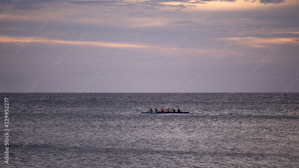 A group of people paddling a large canoe, Hawaii, Big Island