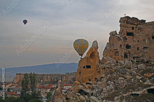 hot air balloons flying over rocks in cappadocia