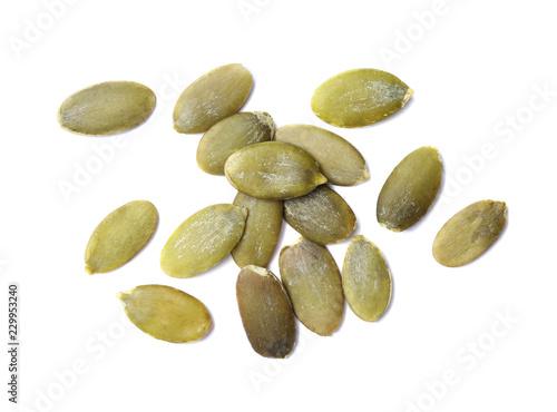 Pile of raw pumpkin seeds on white background, top view
