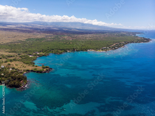 Aerial view at Waialea beach, Big Island, Hawaii with visible underwater rocks