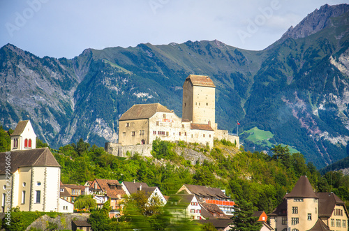 Old castle in front of mountains Alps near Vaduz town, Liechtenstein photo