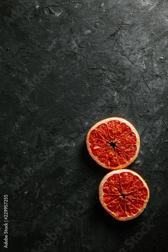 grapefruit slices. Fruit chips on a black background. Festive new year or Christmas design element. 8 March