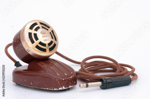 Retro microphone, round and golden, with wire and plug