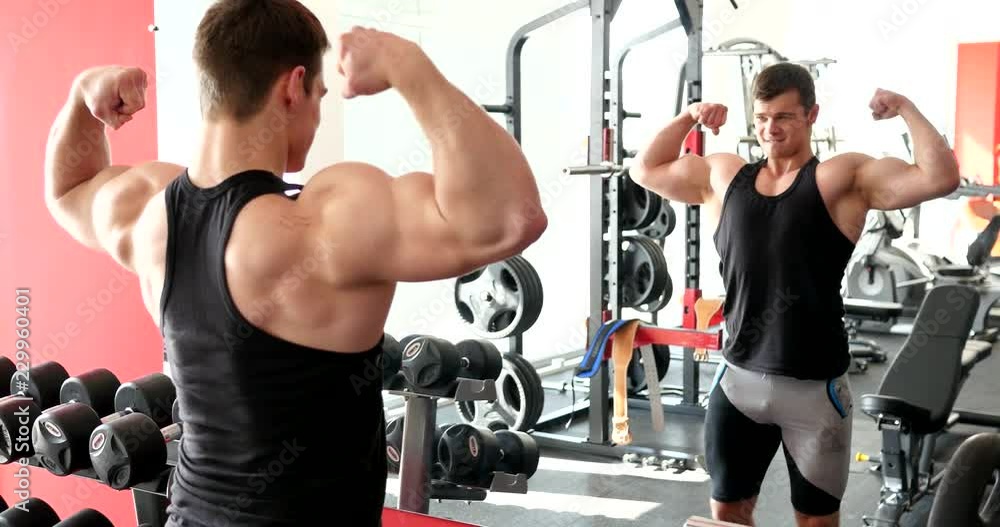 Young strong man hard workout in gym Young strong man hard workout in gym