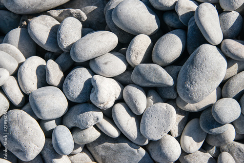 Smooth grey pebbles on a beach