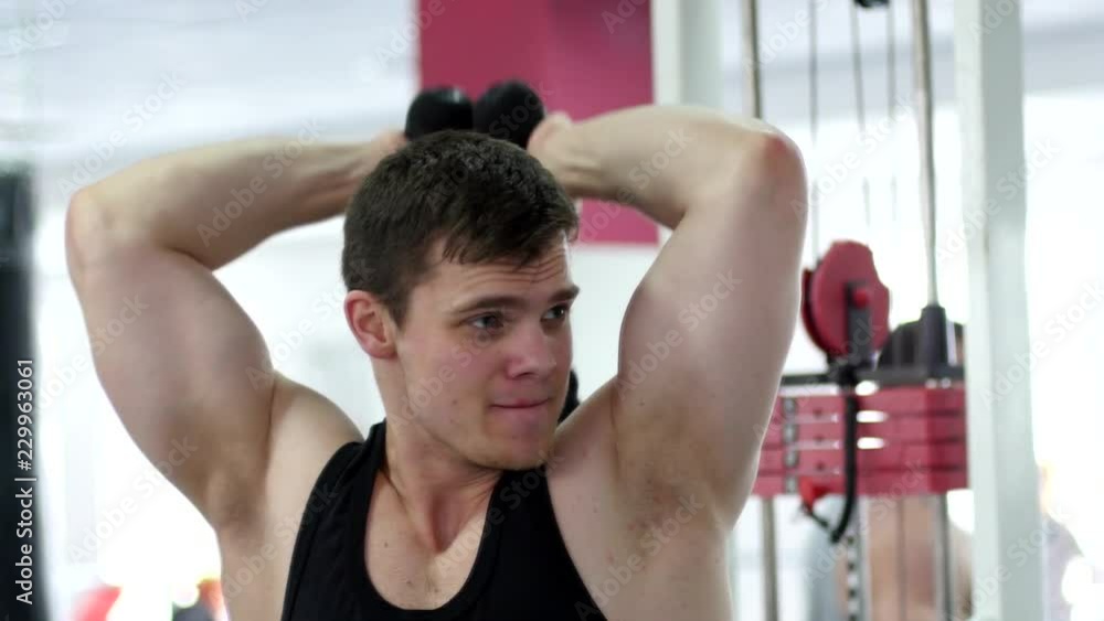 Young muscular man hard training in gym Young muscular man hard training in gym