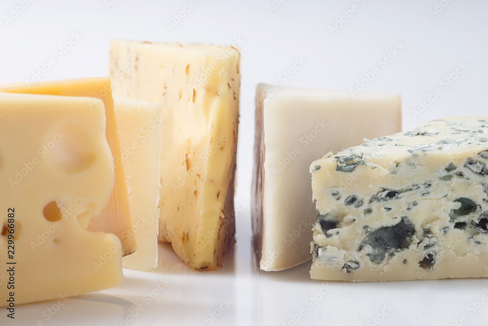 Different kinds of cheeses isolated on white background. Different kinds of cheeses isolated on white background.