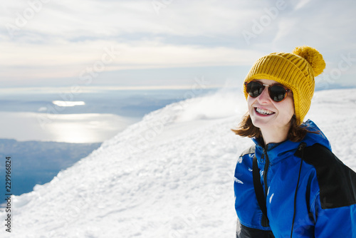 Portrait of a woman on the summit of a snow covered mountain photo