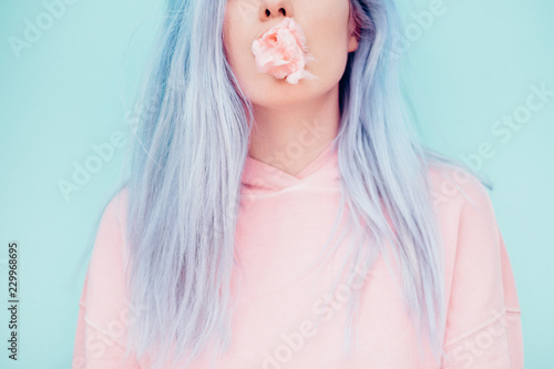 Woman Chewing Pastel Cotton Candy photo