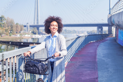 Afro Young Woman With Bicycle Enjoying Free Time In City