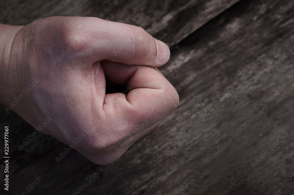 Fist on wooden background