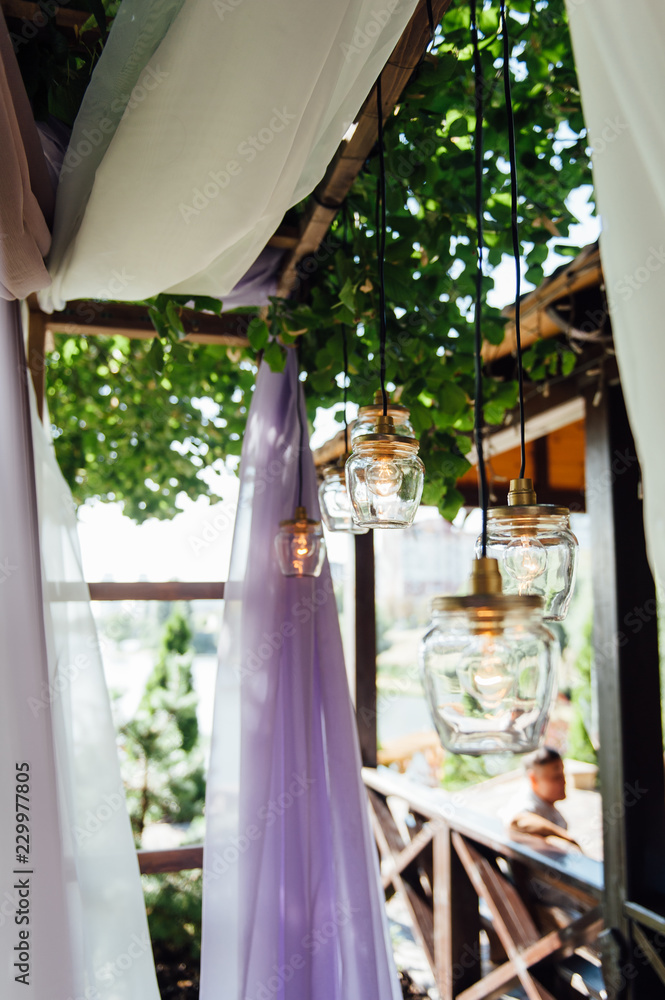 Light bulb decor in outdoor wedding ceremony
