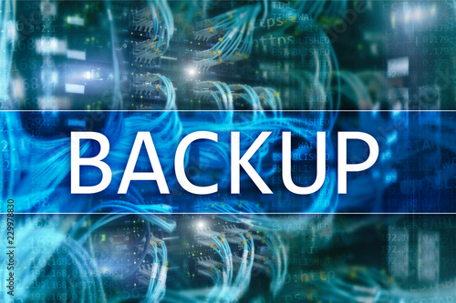 Backup button on modern server room background. Data loss prevention. System recovery.