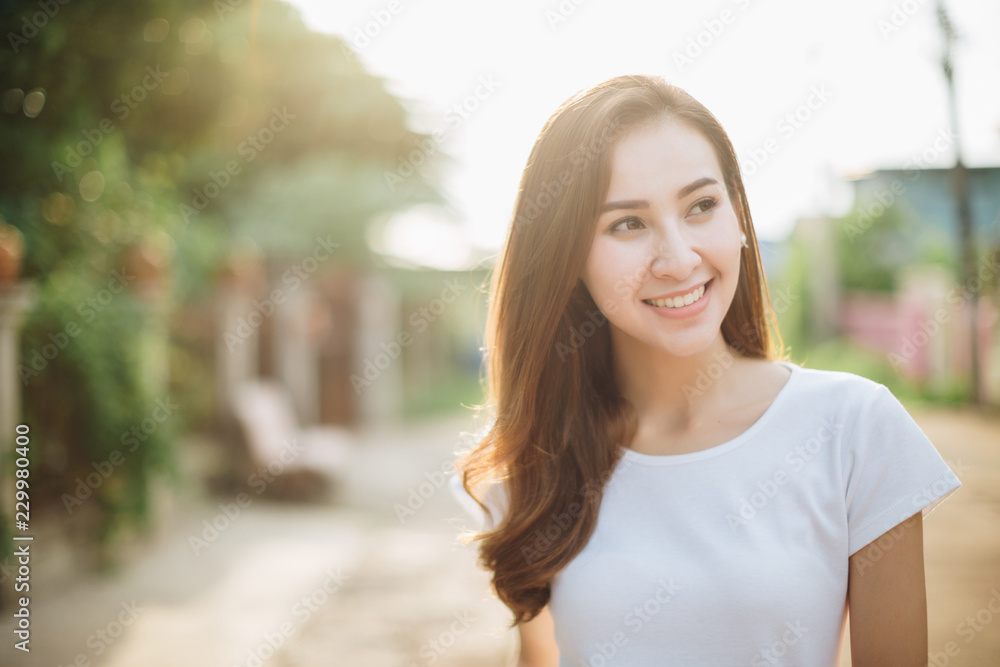 A happy young woman enjoying the autumn on the street